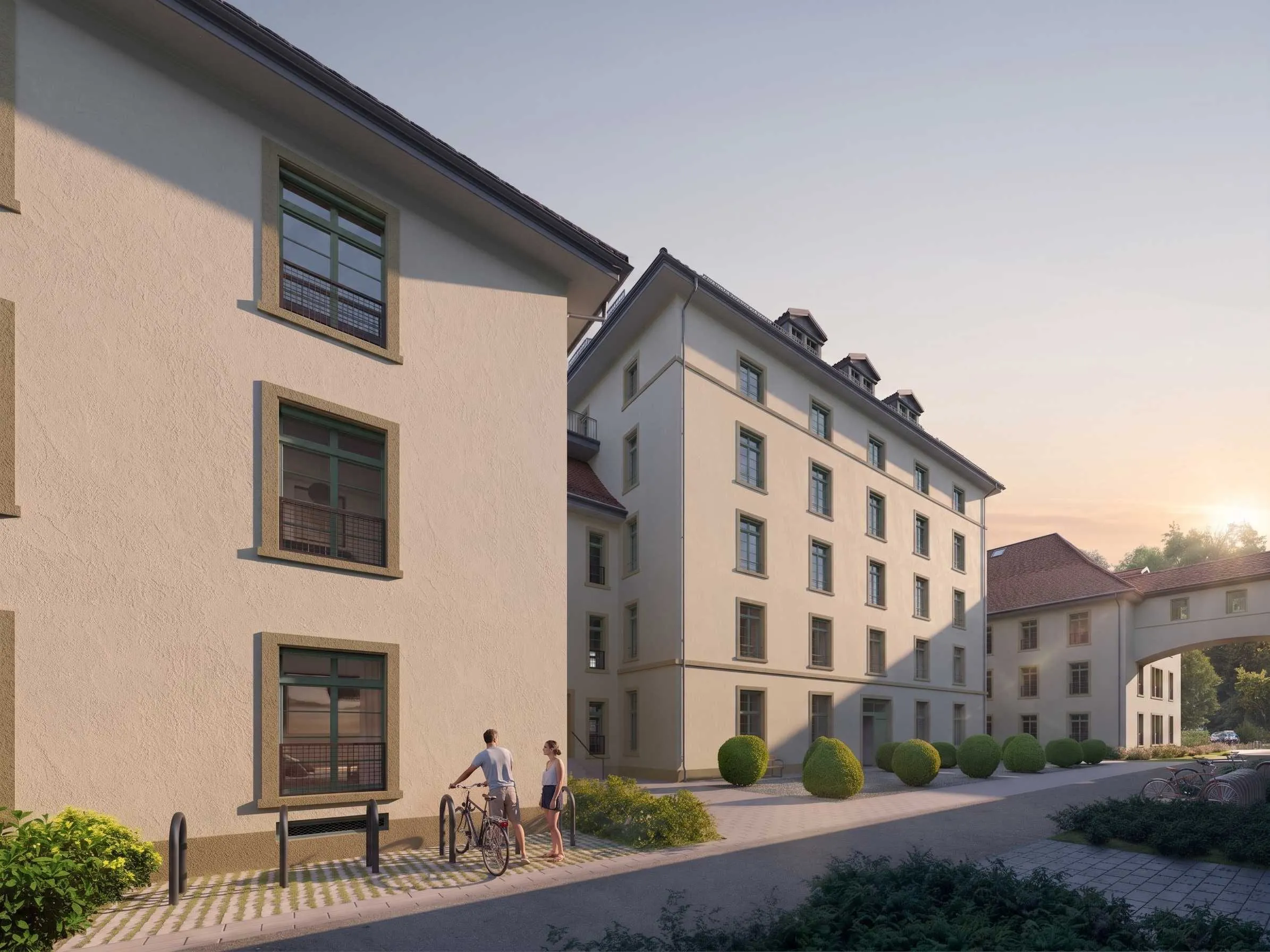 Zwei Personen mit Velo beim Veloständer vor dem Walzmühlehaus